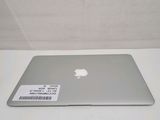 a silver apple laptop sitting on a white table