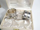 a silver cup and spoon in a box on a table