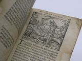 an old book with a picture of a man holding a sword