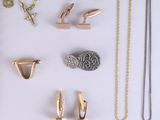 many different types of jewelry on a white surface