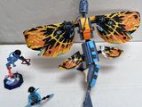a toy dragonfly with a sword and other toy figures around it