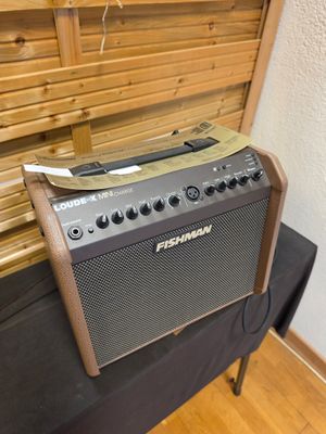 an electric guitar amplifier sitting on top of a table next to a wall