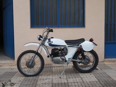 a white motorcycle parked in front of a building