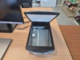 a laptop computer sitting on a desk with a printer on it