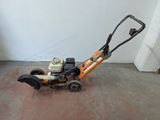 a small lawn mower that is sitting on the floor
