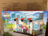 Ensemble « Lego City : La boulangerie » dans une boîte posée sur une table devant une fenêtre