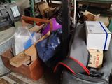 a pile of luggage sitting on a pallet in a warehouse