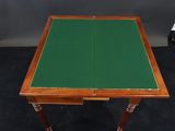 an old wooden table with a green cloth on top