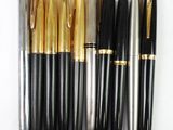 several different types of pens are lined up on a white surface