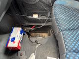a spider web on the seat of a car with a box of toothpaste