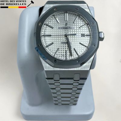 an image of a watch is displayed on a stand on a white surface