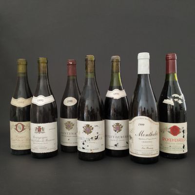 several bottles of wine are lined up on a table