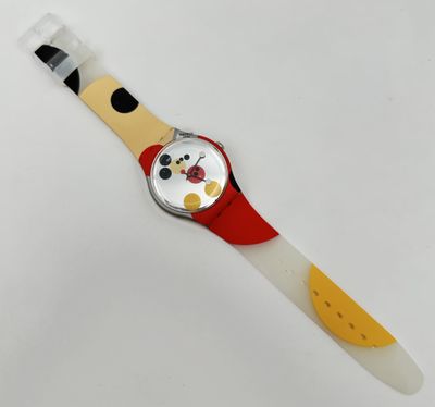 a close up of a watch on a white surface