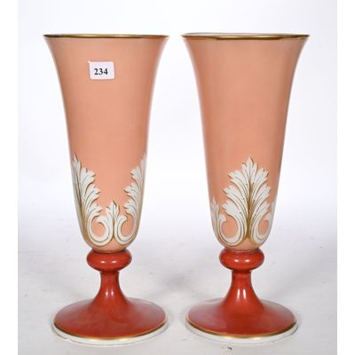 two vases that are sitting on a table