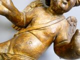 a statue of an angel laying down on the ground