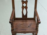 a wooden chair that has a mirror on the back of it
