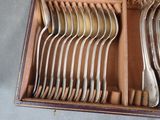 a lot of spoons and forks in a box