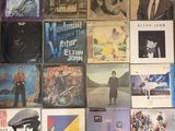 a lot of records on the wall of a room