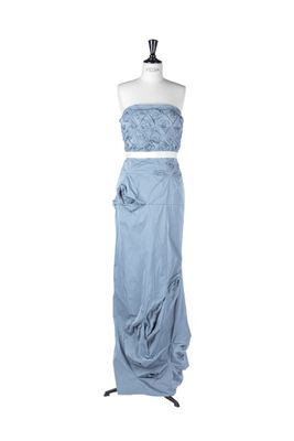 a dress on a mannequin stand with a white background