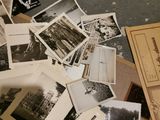 a pile of old black and white photos on the floor