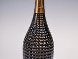 a close up of a bottle of champagne on a white surface