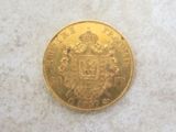 a close up of a gold coin on a white surface