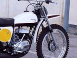 a white and yellow motorcycle parked in front of a building