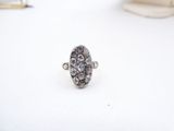 an image of a silver ring sitting on top of a white table