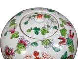 a white bowl with colorful flowers and leaves on it