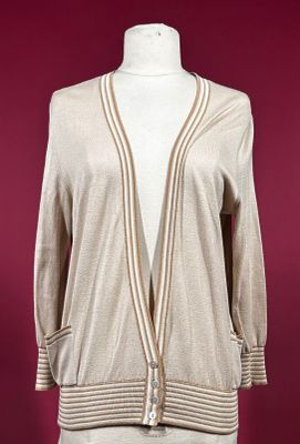 a woman ' s beige cardigan sweater on a mannequin mannequin mannequin mannequin mannequin mannequin mannequin mann