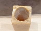 a wooden block with a hole in it on a table