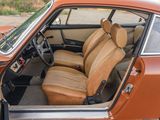 an orange car with leather seats in the back of it