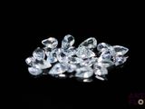 a close up of a bunch of diamonds on a black surface