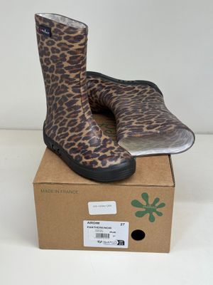 pair of leopard print rain boots sitting on top of a cardboard box