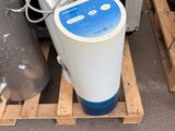 a water purifier sitting on a pallet next to a microwave