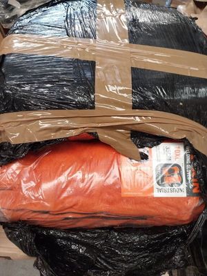 a large bag of orange and black stuff on the back of a motorcycle