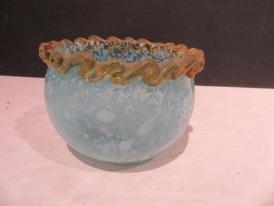 a blue vase with a gold rim sitting on a table