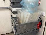 a stack of plastic containers in the corner of a room