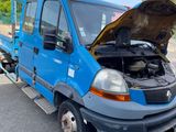 a blue truck that has a broken hood on it
