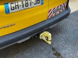 a yellow car that has a yellow banana on the ground