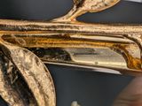 a gold spoon and spoon rest on a black table