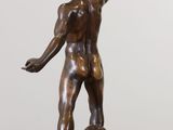 bronze statue of a man holding a fan on a marble base