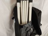 a black bag with a bunch of books inside of it