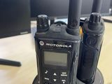 two motorola walkie talkies sitting on top of a table