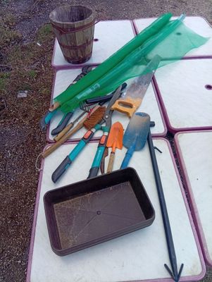 a table with a bunch of gardening tools on it