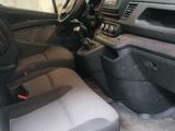 the interior of a car with the door open and the driver ' s seat down