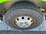 a close up of a tire on a green vehicle