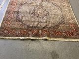 rug on the floor in the middle of a room with a lot of furniture in the background