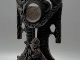 a statue of a man holding a mirror on a stand