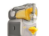 an image of a juicer with a glass of orange juice